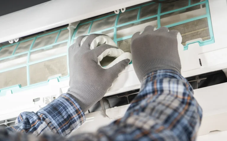 Denver technician cleans air conditioning unit
